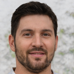 Joyful white adult male with short  brown hair and brown eyes