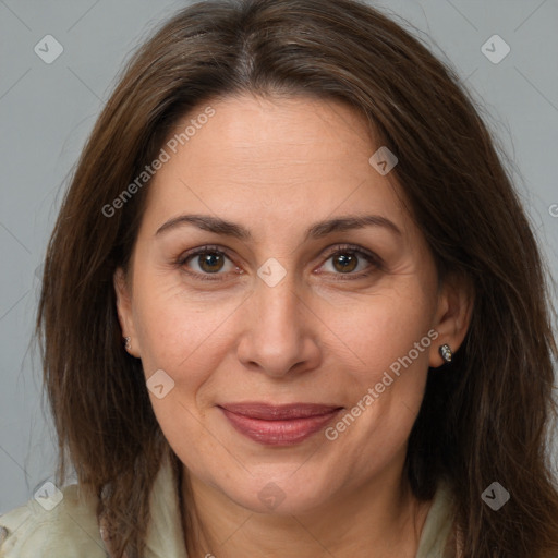 Joyful white adult female with long  brown hair and brown eyes