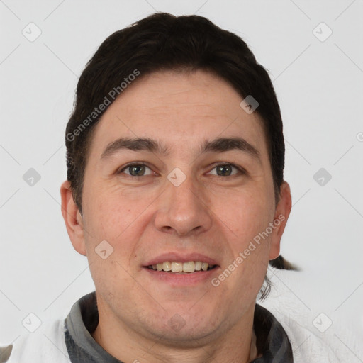 Joyful white adult male with short  brown hair and brown eyes