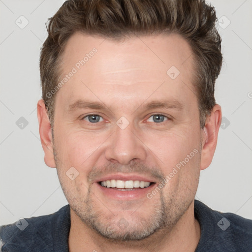 Joyful white adult male with short  brown hair and grey eyes