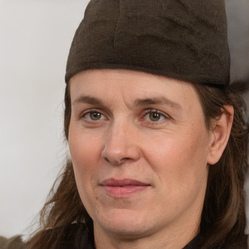 Joyful white adult female with medium  brown hair and grey eyes