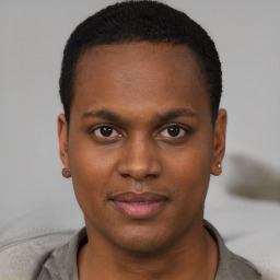 Joyful black young-adult male with short  brown hair and brown eyes