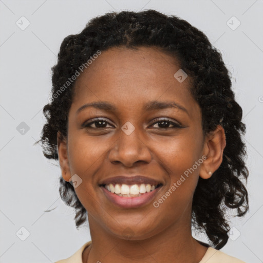 Joyful black young-adult female with long  brown hair and brown eyes