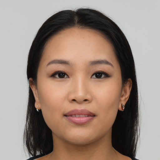 Joyful asian young-adult female with long  black hair and brown eyes