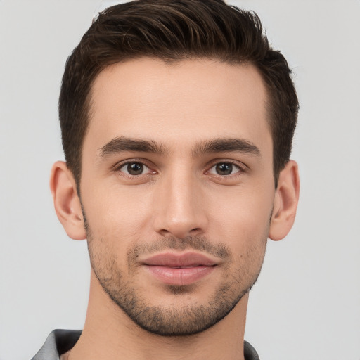 Joyful white young-adult male with short  brown hair and brown eyes