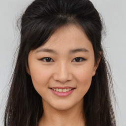 Joyful asian young-adult female with long  brown hair and brown eyes