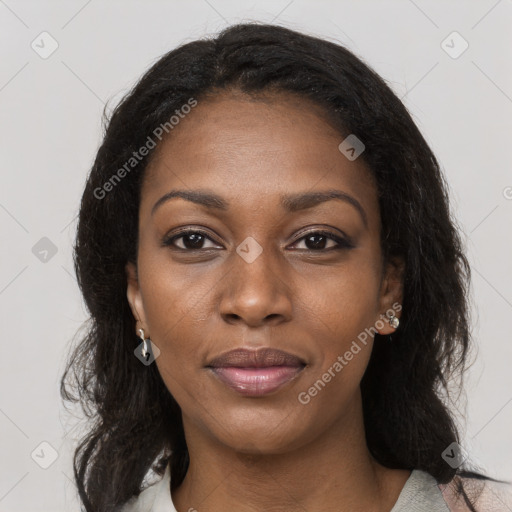 Joyful black young-adult female with long  brown hair and brown eyes