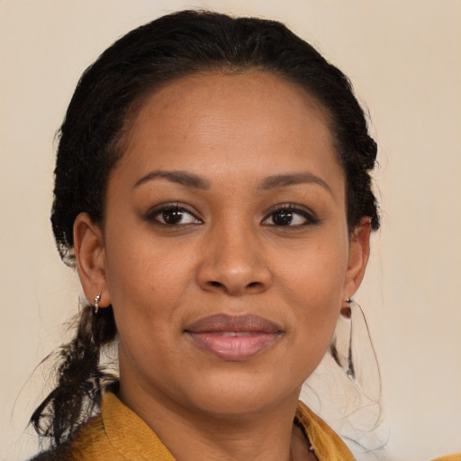 Joyful black young-adult female with medium  brown hair and brown eyes