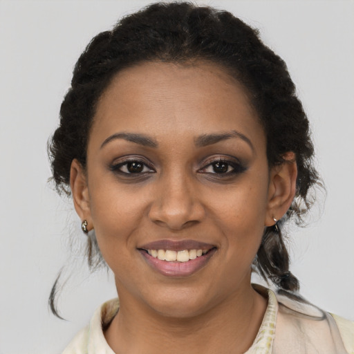 Joyful black young-adult female with medium  brown hair and brown eyes