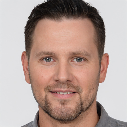 Joyful white adult male with short  brown hair and brown eyes