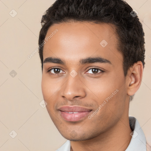 Joyful latino young-adult male with short  brown hair and brown eyes