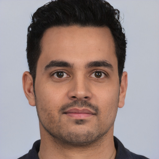 Neutral latino young-adult male with short  black hair and brown eyes