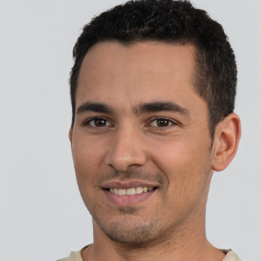 Joyful white young-adult male with short  black hair and brown eyes