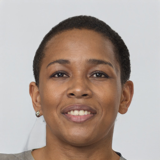 Joyful black young-adult female with short  brown hair and brown eyes