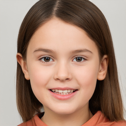 Joyful white child female with long  brown hair and brown eyes