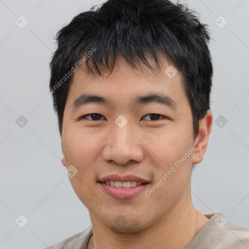 Joyful asian young-adult male with short  black hair and brown eyes