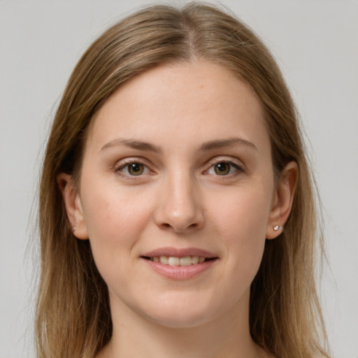 Joyful white young-adult female with long  brown hair and grey eyes