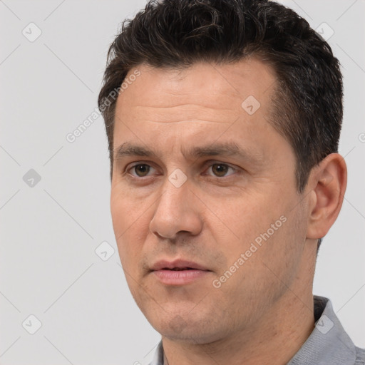 Joyful white adult male with short  brown hair and brown eyes