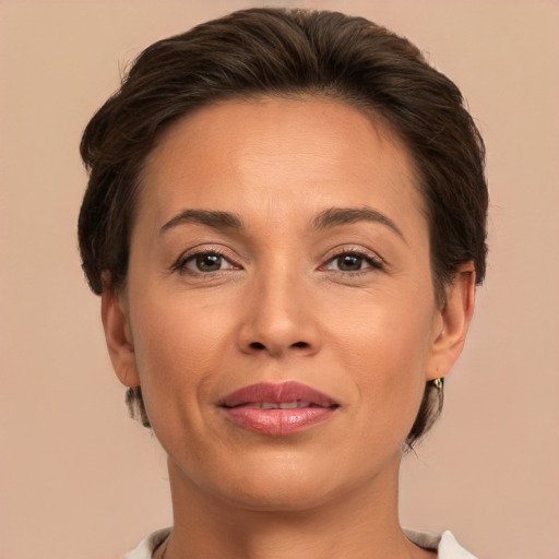 Joyful white adult female with short  brown hair and brown eyes