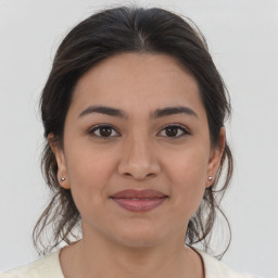 Joyful latino young-adult female with medium  brown hair and brown eyes