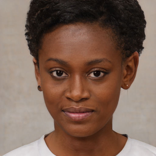 Joyful black young-adult female with short  brown hair and brown eyes