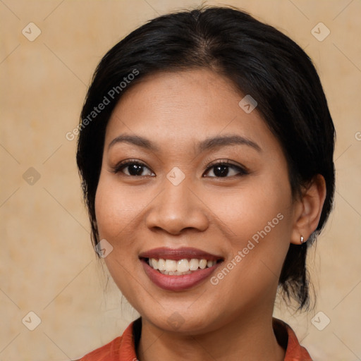 Joyful asian young-adult female with medium  brown hair and brown eyes