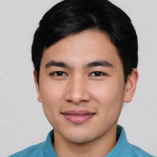 Joyful asian young-adult male with short  brown hair and brown eyes