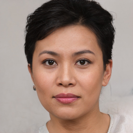 Joyful asian young-adult female with short  black hair and brown eyes