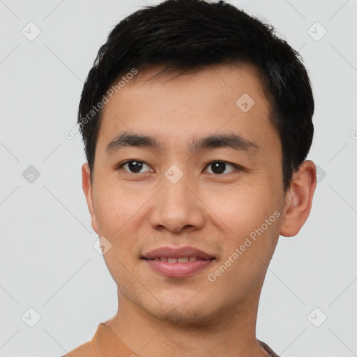 Joyful asian young-adult male with short  black hair and brown eyes