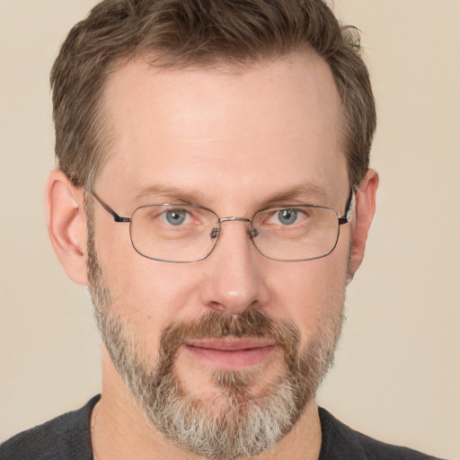 Joyful white adult male with short  brown hair and grey eyes