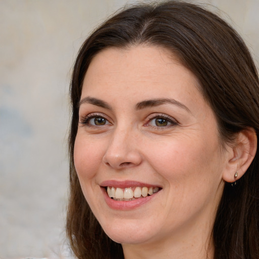 Joyful white adult female with long  brown hair and brown eyes