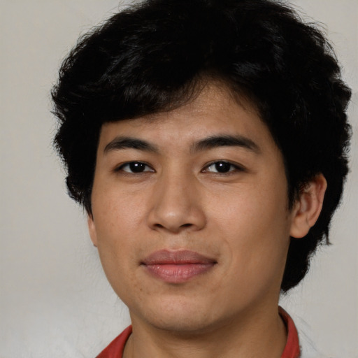 Joyful latino young-adult male with short  brown hair and brown eyes