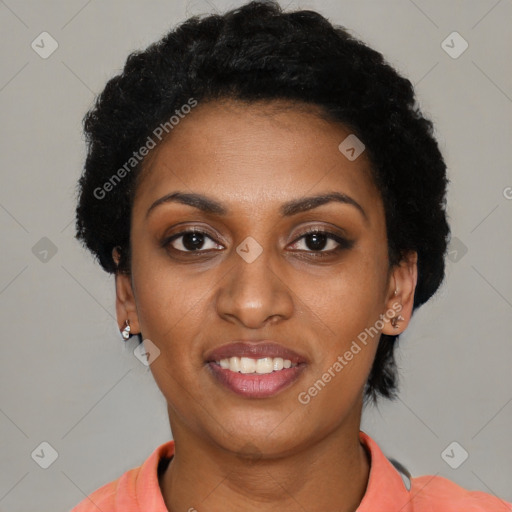 Joyful black young-adult female with short  black hair and brown eyes