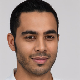 Joyful latino young-adult male with short  brown hair and brown eyes