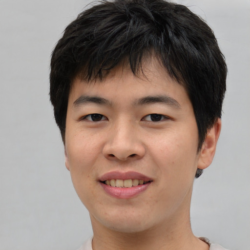 Joyful asian young-adult male with short  brown hair and brown eyes