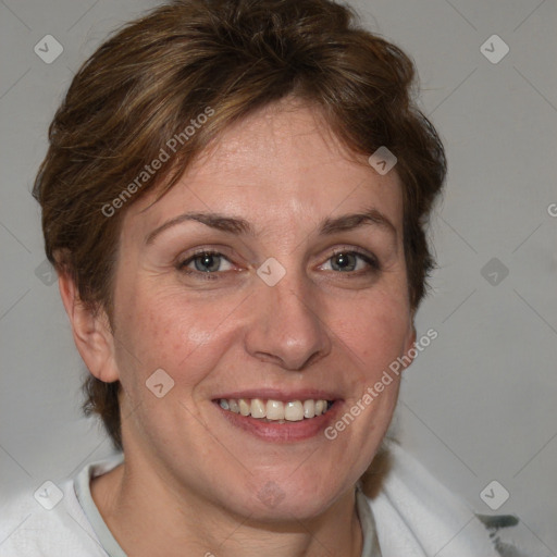 Joyful white adult female with short  brown hair and blue eyes