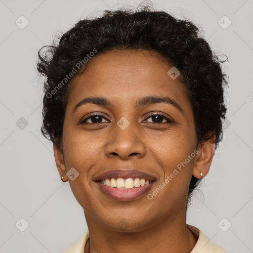 Joyful black young-adult female with short  black hair and brown eyes