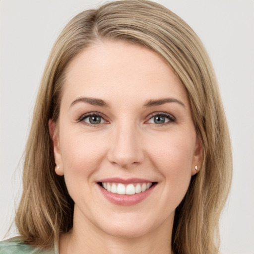 Joyful white young-adult female with long  brown hair and green eyes