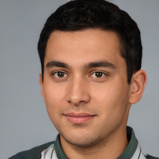 Joyful white young-adult male with short  black hair and brown eyes