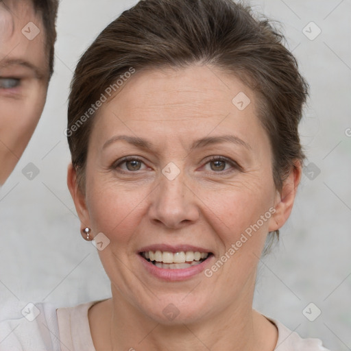 Joyful white adult female with short  brown hair and brown eyes