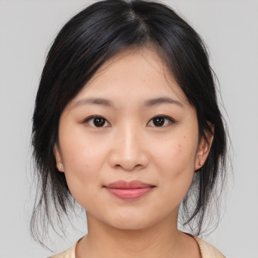 Joyful asian young-adult female with medium  brown hair and brown eyes