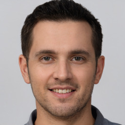 Joyful white young-adult male with short  brown hair and brown eyes