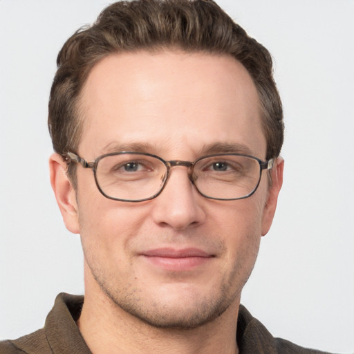 Joyful white adult male with short  brown hair and grey eyes