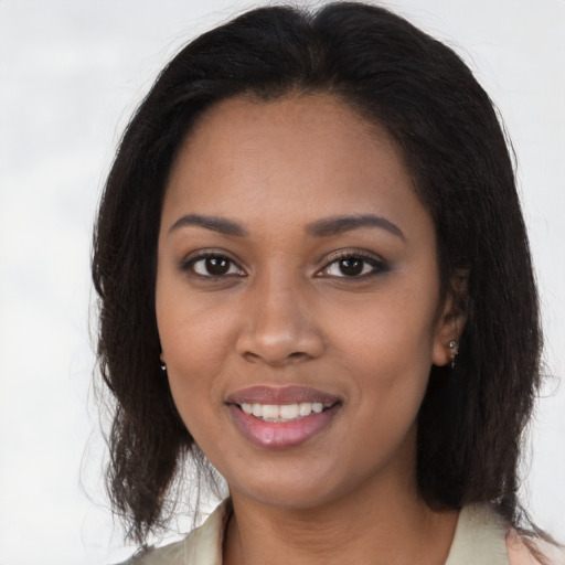 Joyful black young-adult female with medium  brown hair and brown eyes