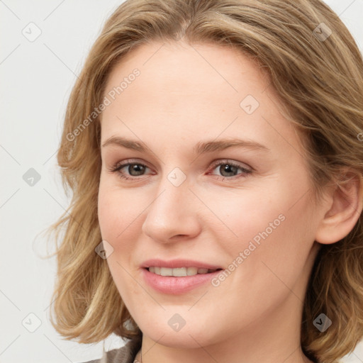 Joyful white young-adult female with medium  brown hair and blue eyes