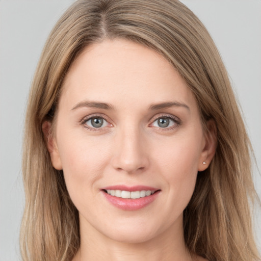 Joyful white young-adult female with long  brown hair and grey eyes