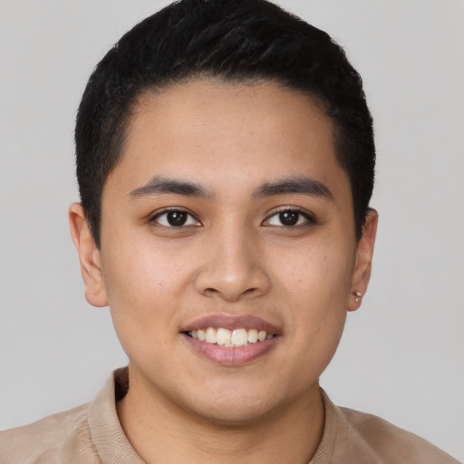 Joyful latino young-adult male with short  brown hair and brown eyes