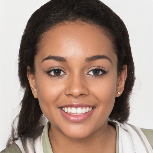 Joyful latino young-adult female with long  brown hair and brown eyes