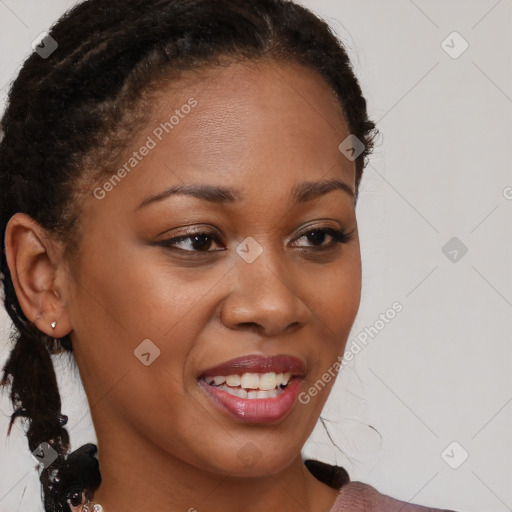 Joyful black young-adult female with long  brown hair and brown eyes