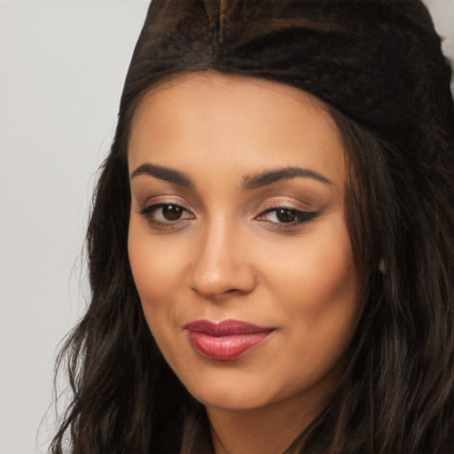 Joyful latino young-adult female with long  black hair and brown eyes